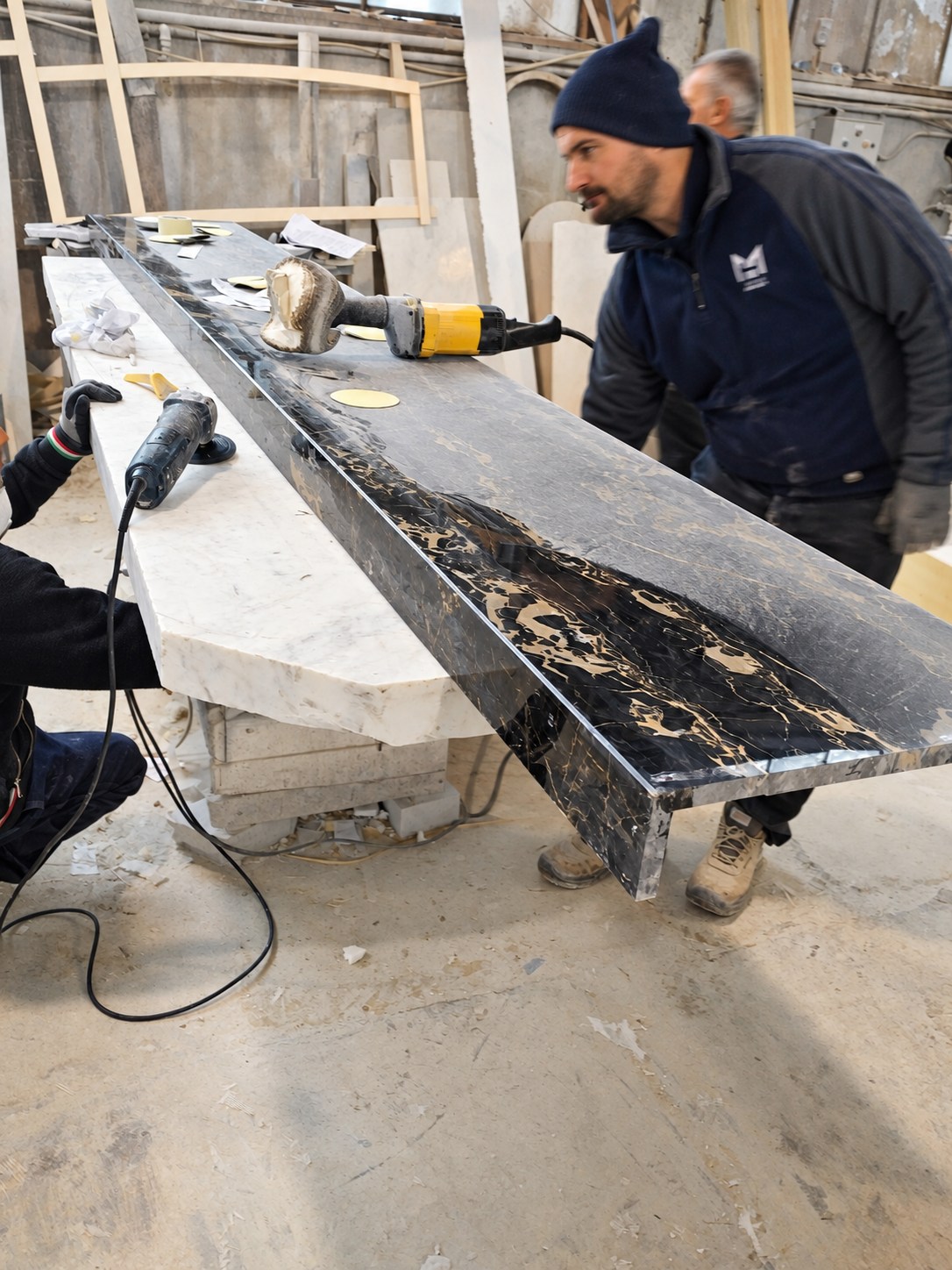 Artisans working on a bespoke Portoro stone element.