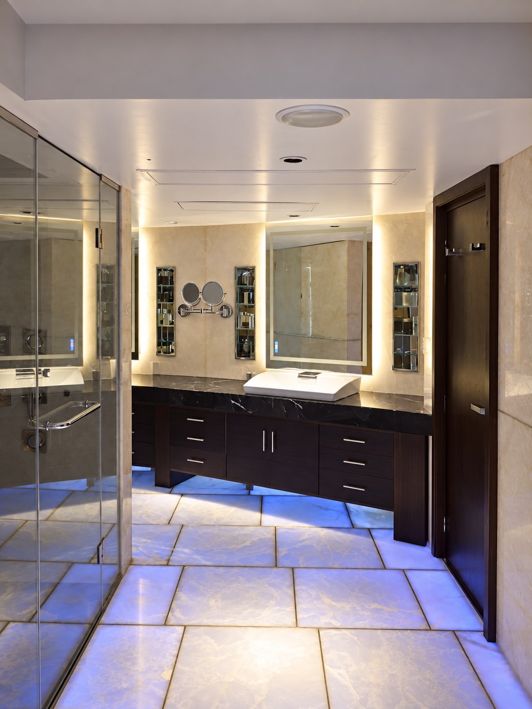 Bathroom with blue-violet backlighting beneath the onyx floor.