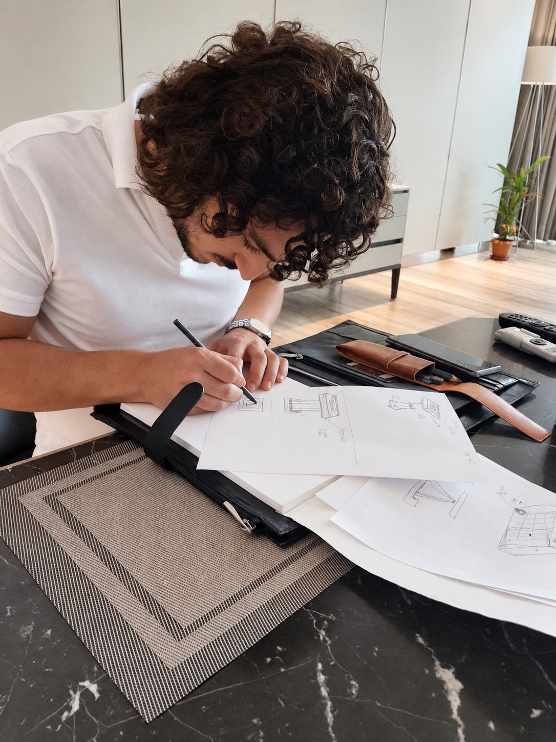 Hand sketching and design development at the work table.