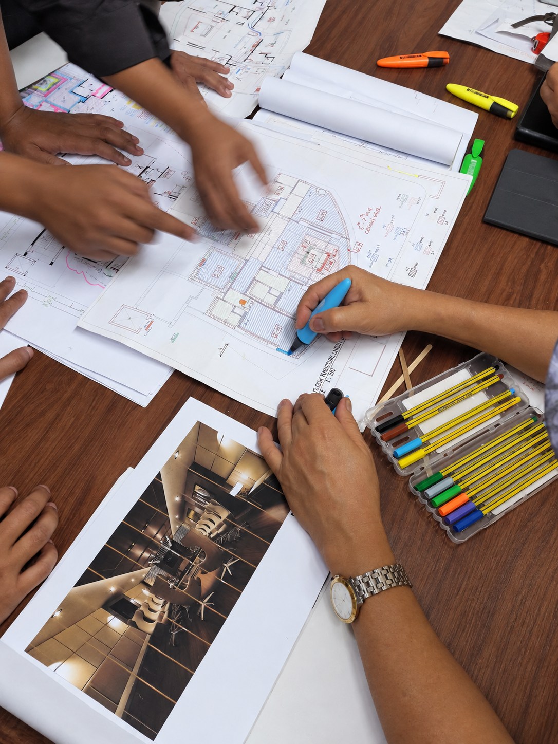 Team reviewing drawings and an interior visualization.
