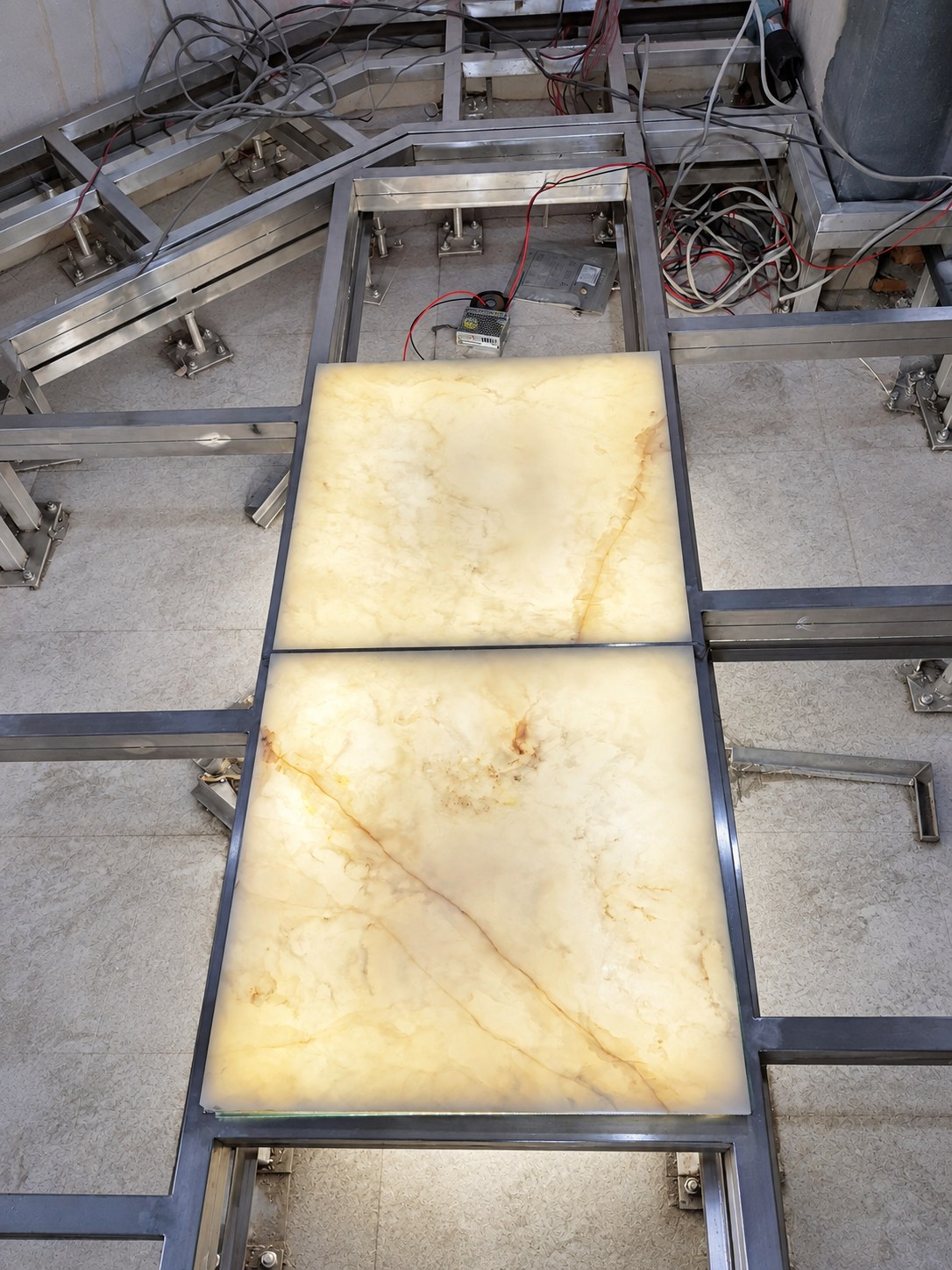 AI-retouched installation view of the backlit onyx floor at Sikder Haus.