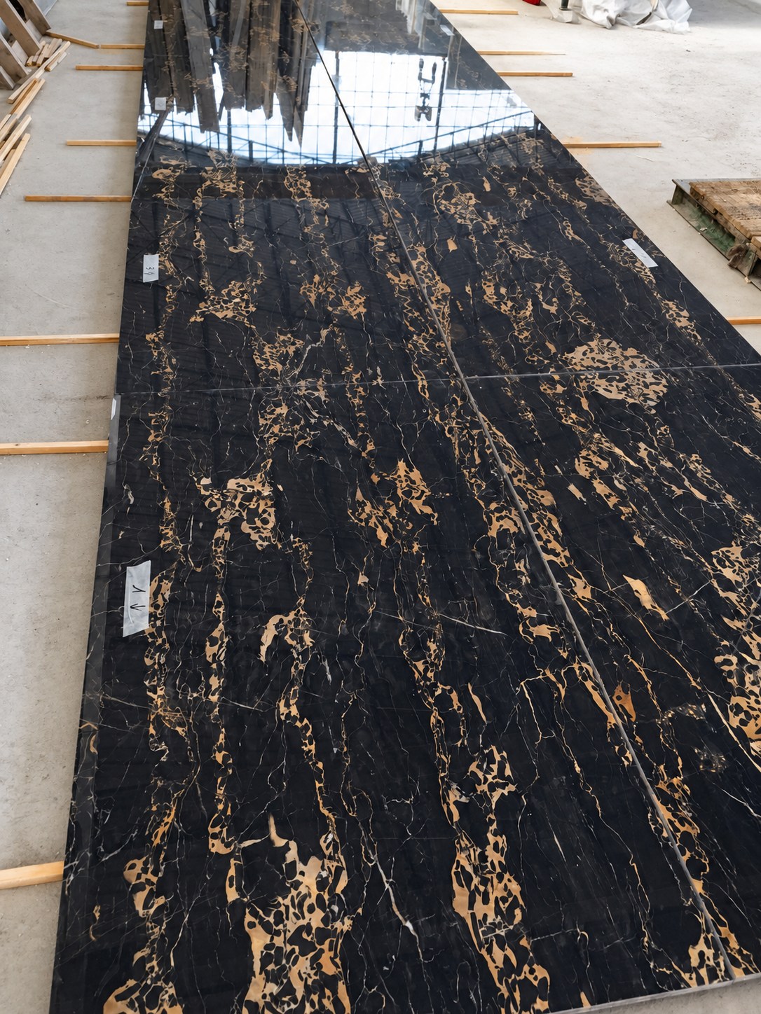 Portoro slabs laid out in the workshop.