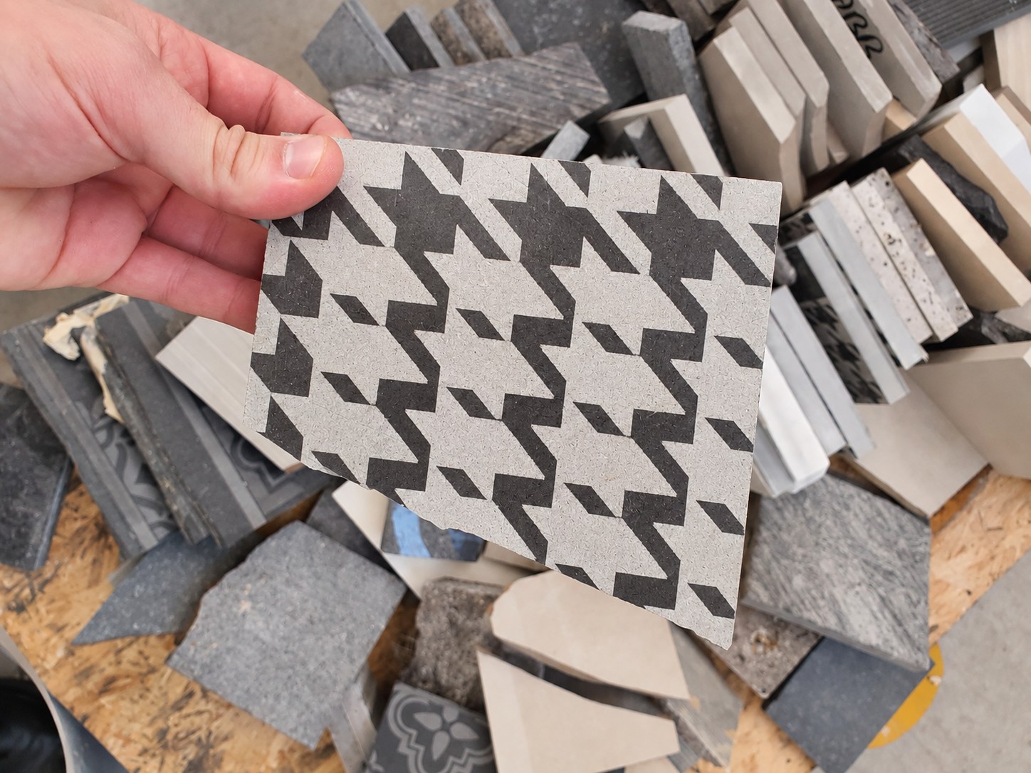 Geometric stone finish sample held in hand.