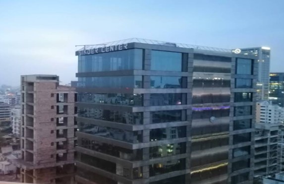 Sikder Center exterior, with the building name visible on its roofline.