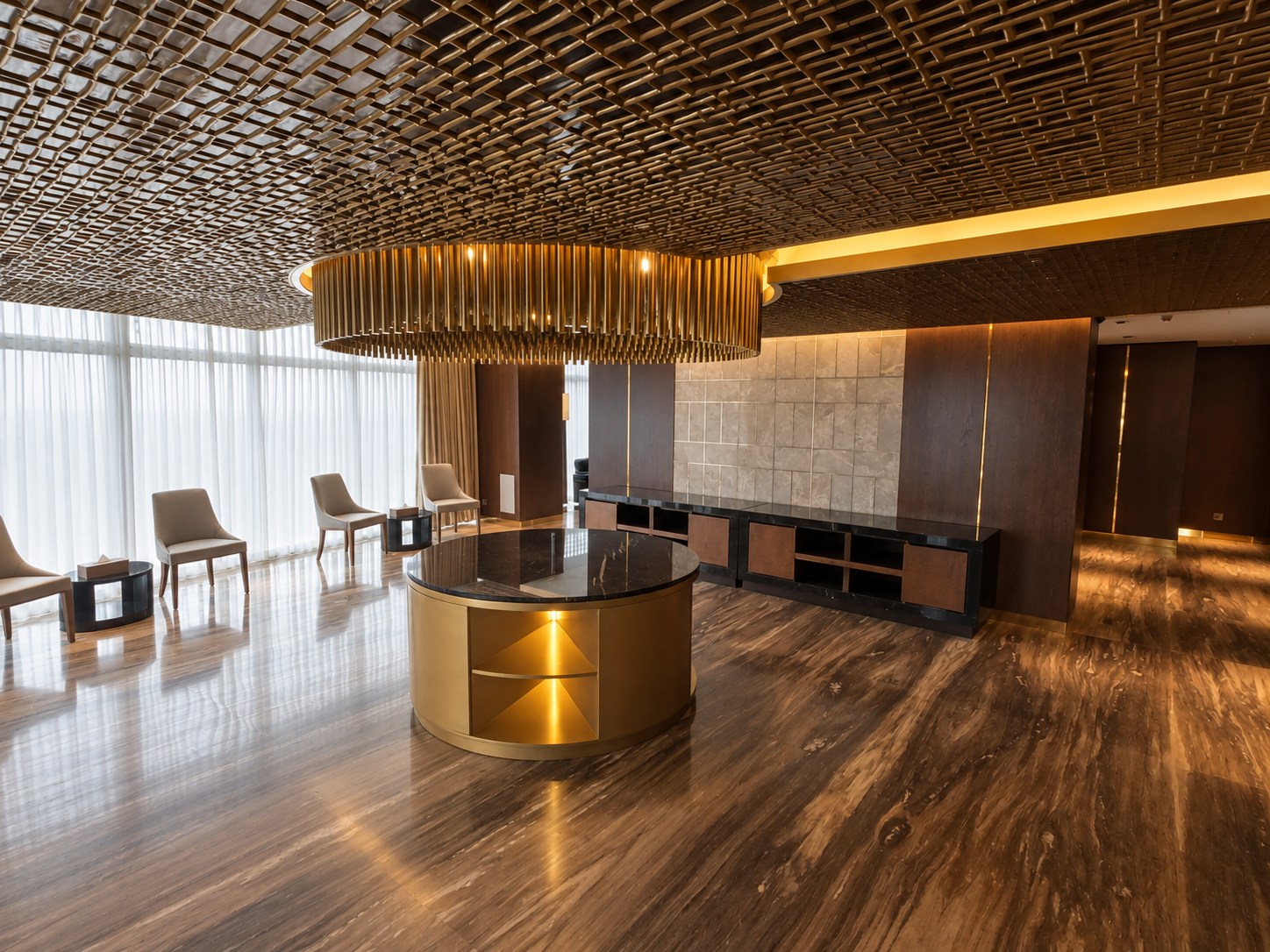 Sikder Haus, 12th floor reception: circular brass island and chandelier. Editorially enhanced photograph.
