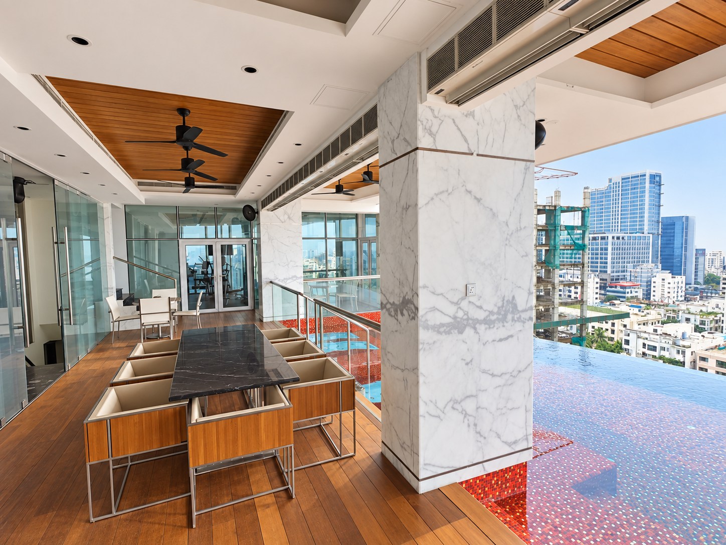 Sikder Haus, 15th floor terrace and pool edge overlooking Dhaka. Editorially styled photograph.